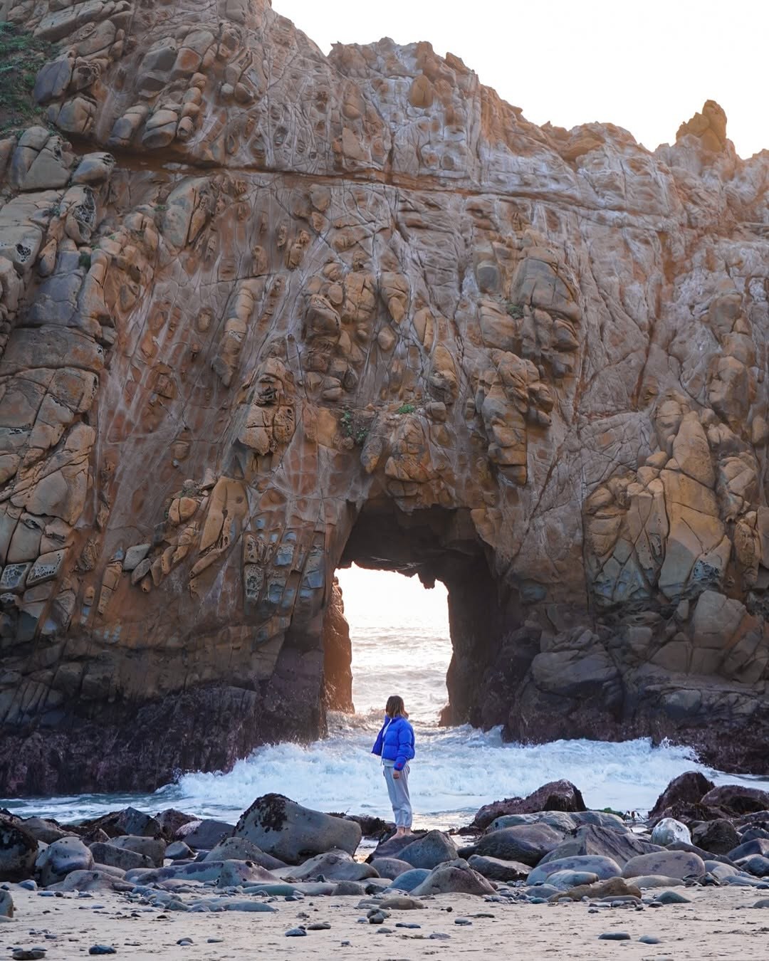 Keyhole Arch at Pfeiffer Beach in Big Sur with Polina standing below it