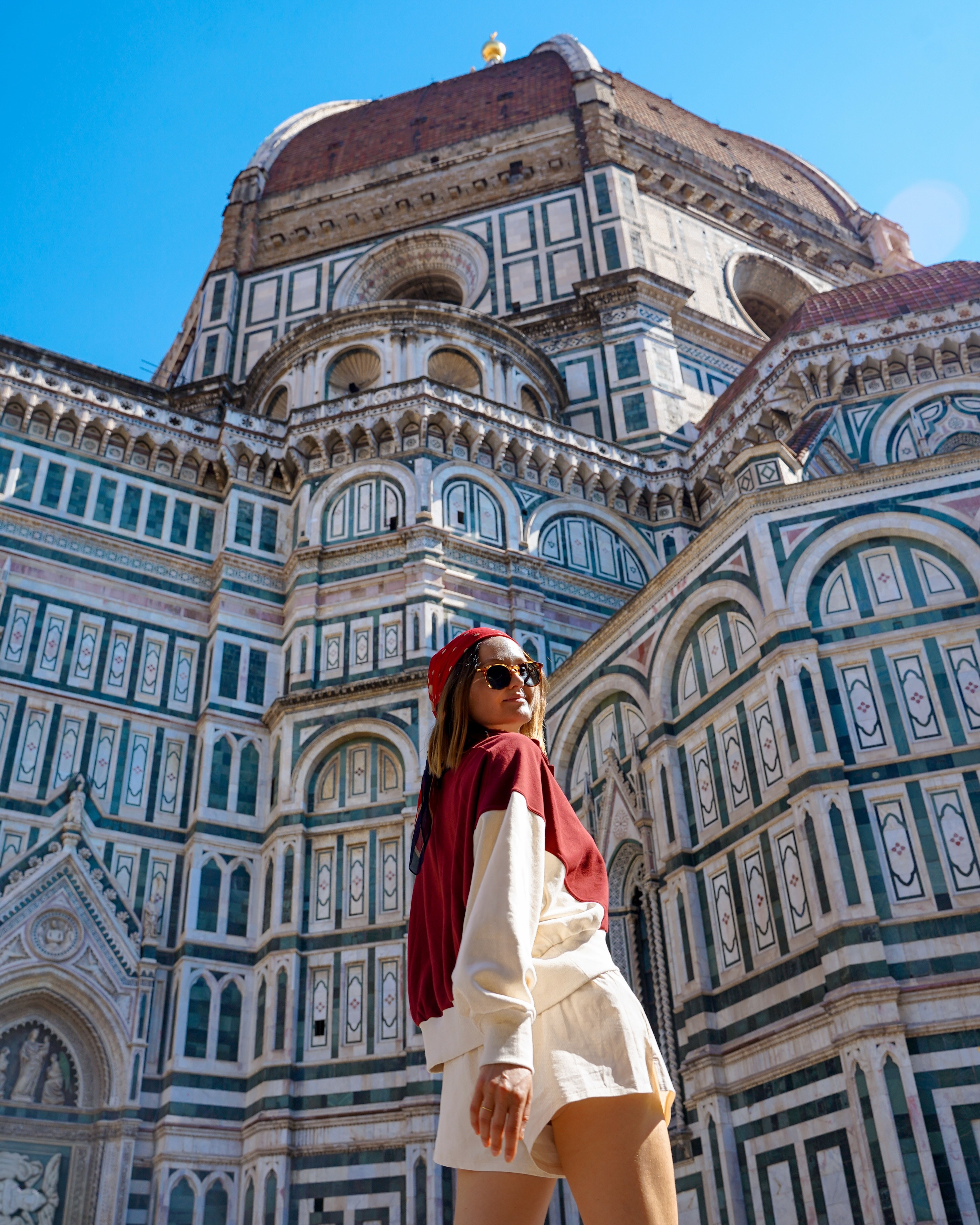 Polina in front of the striped marble facade of Florence Cathedral