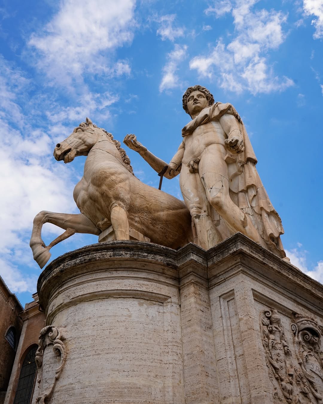 A statue of one of the Dioscuri with his horse at the top of the staircase to Capitoline Hill