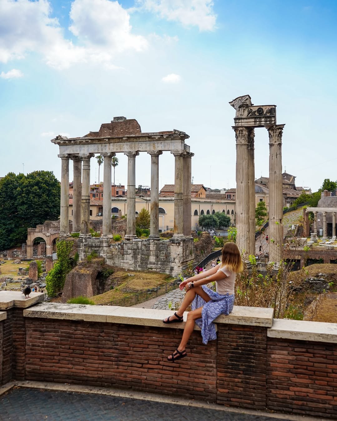 Polina sitting on a wall above the Roman Forum