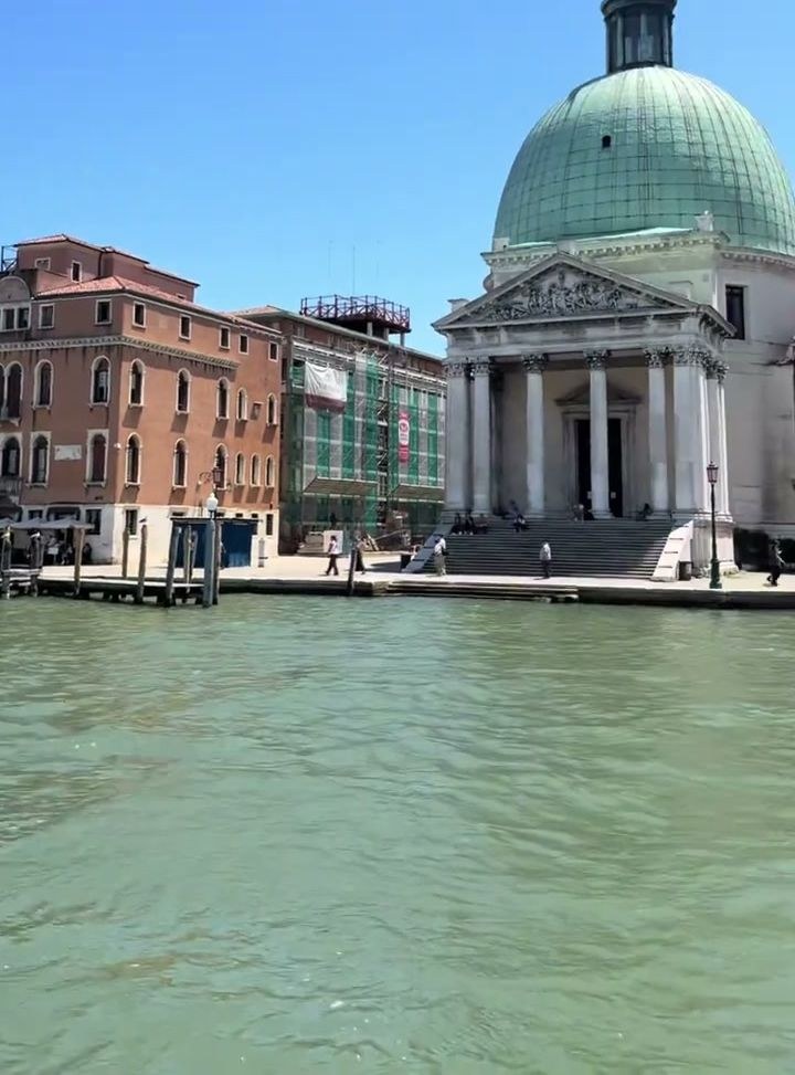 The green-domed church of San Simeone Piccolo seen across the Grand Canal from a vaporetto